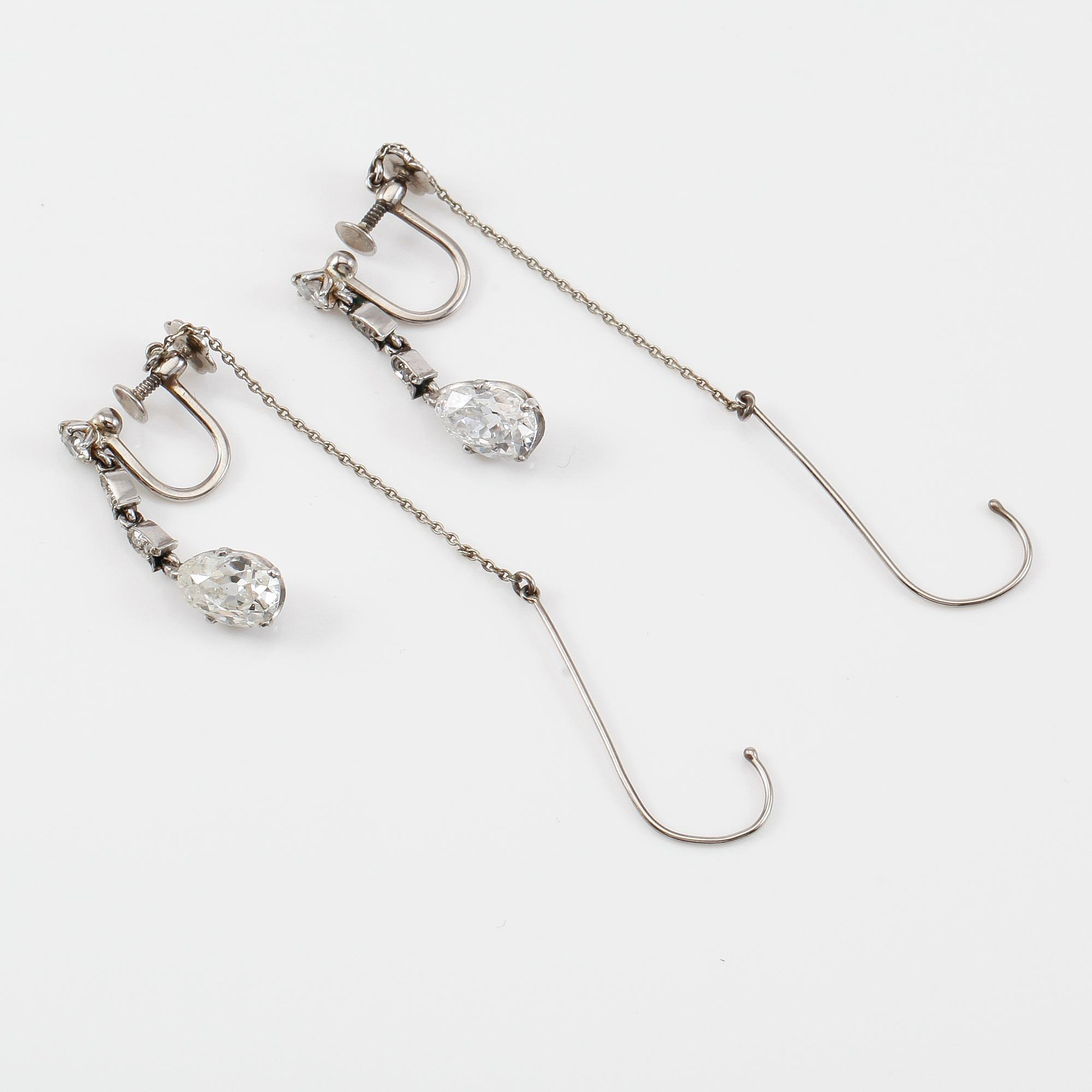 A pair of pear shaped and brilliant-cut diamond earrings. Made by Swedish court jeweller W.A. Bolin, Stockholm 1953.
