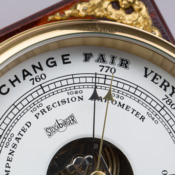 A BRASS MARINE CLOCK AND BAROMETER BY STOCKBURGER.