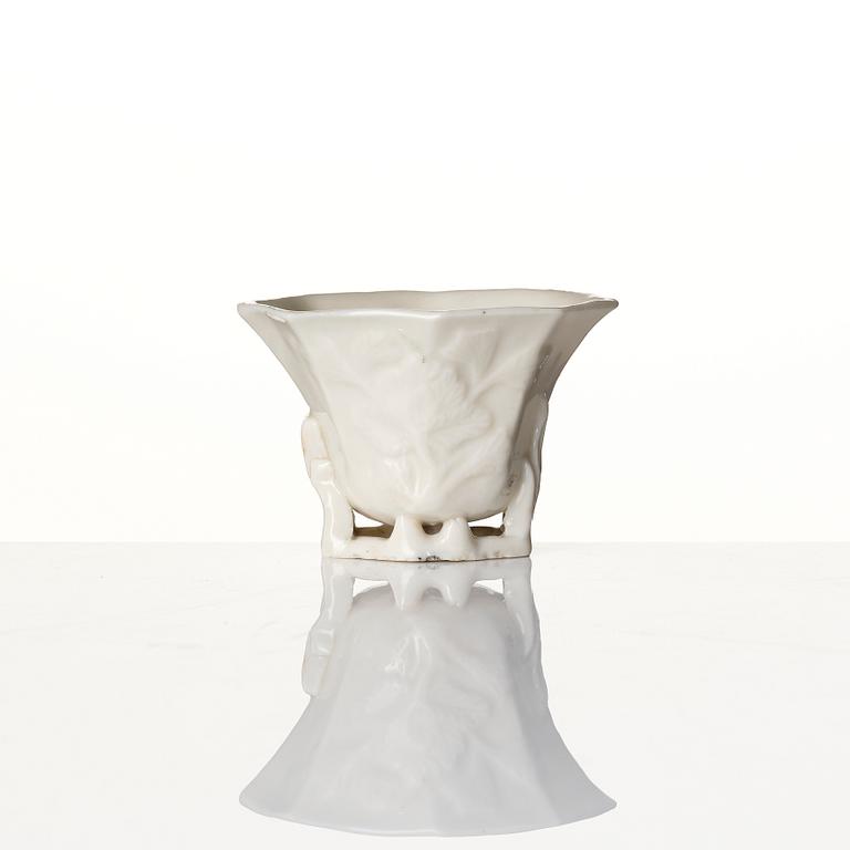 A lacquer tea box and a blanc de chine cup, Qing dynasty 18/19th century.