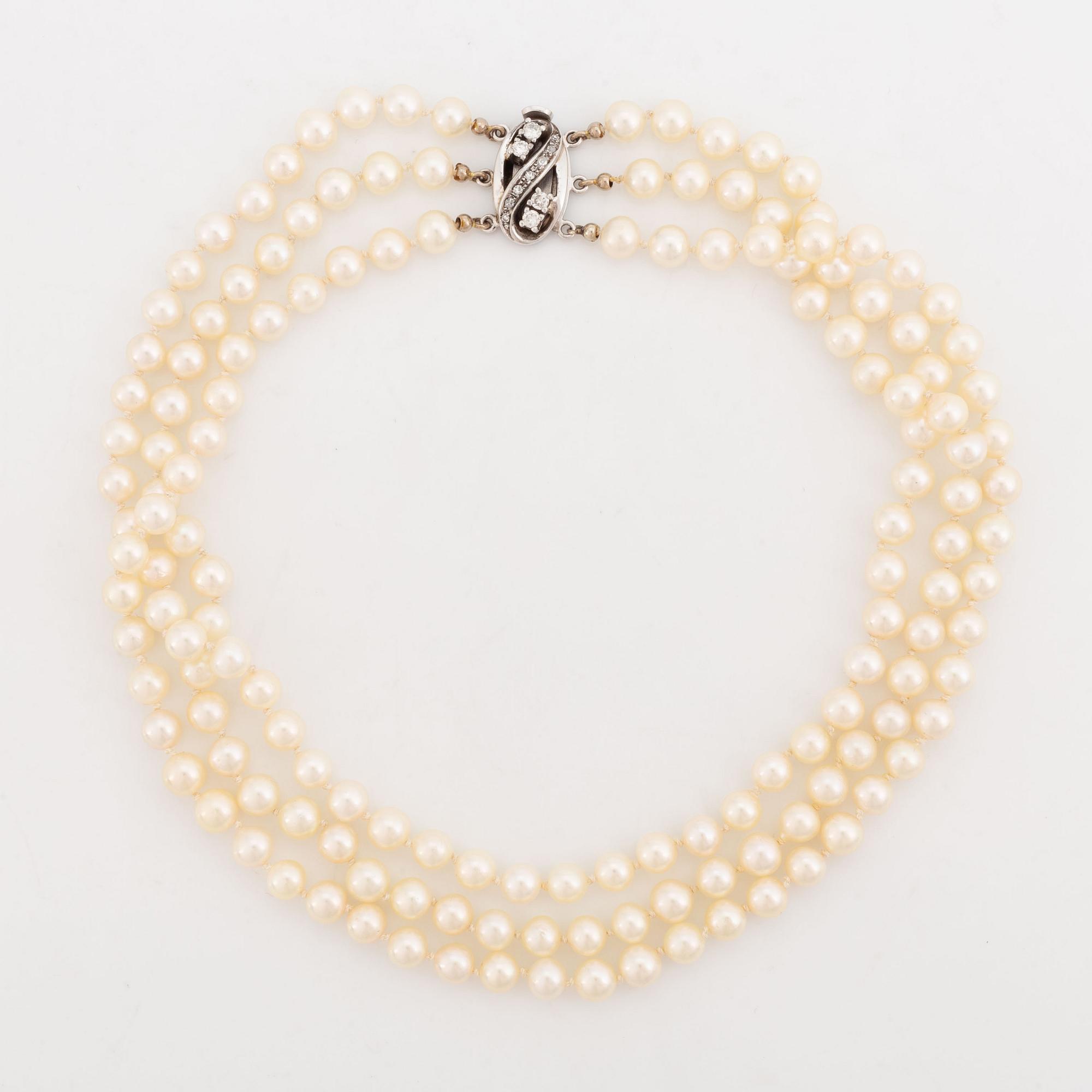 Three strand cultured pearl necklace, clasp with diamonds.