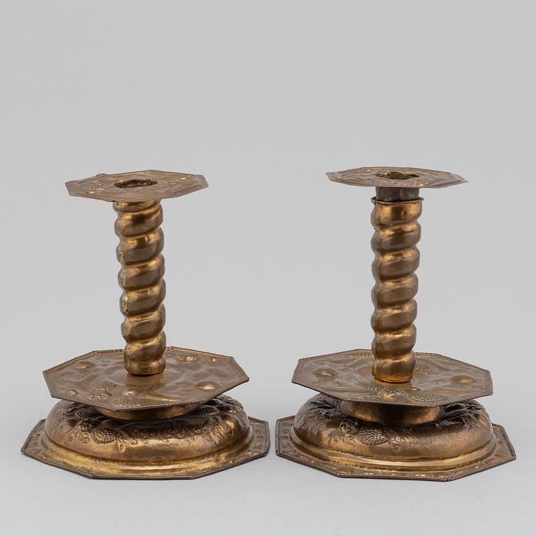 A pair of possibly 17th century brass candlesticks.