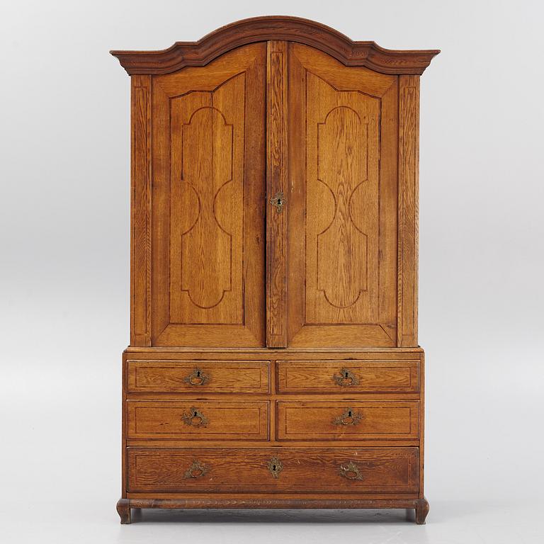 An oak rococo cabinet, mid 18th Century.