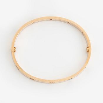 A Cartier "Love" bracelet in 18K rose gold set with colored stones.