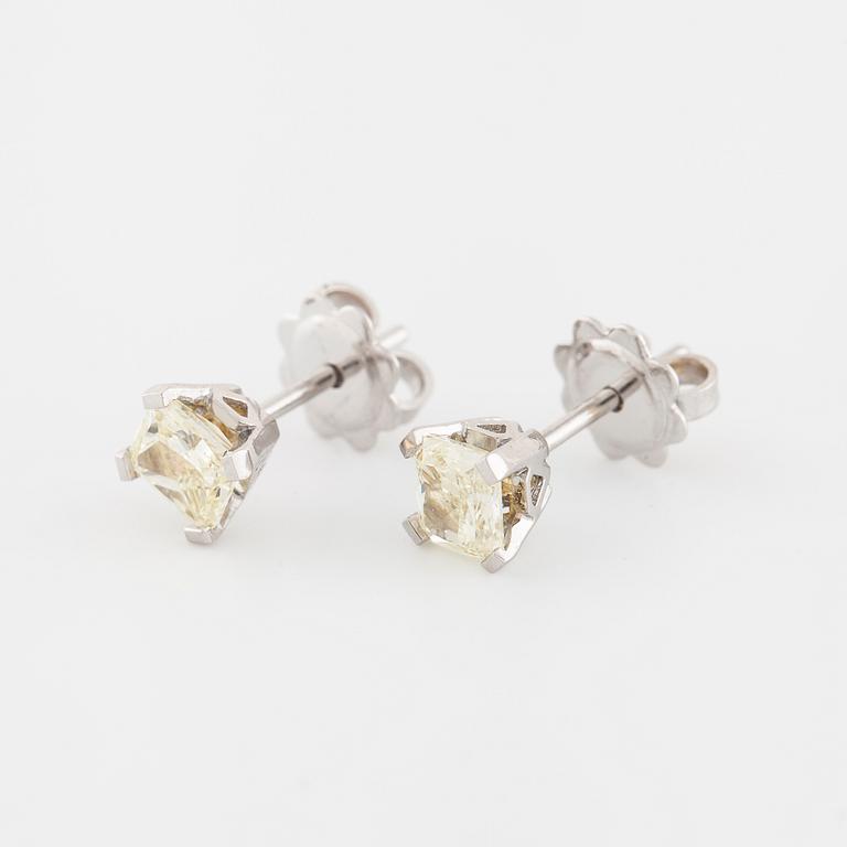 A pair of radiant cut diamond earrings.