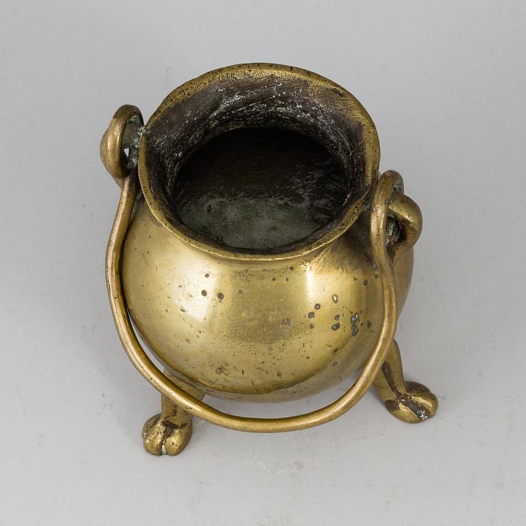 A 17th century brass bowl.
