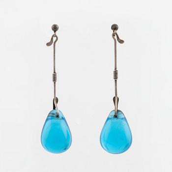 A pair of silver earrings with blue glass drops, likely by Torun Bülow-Hübe.