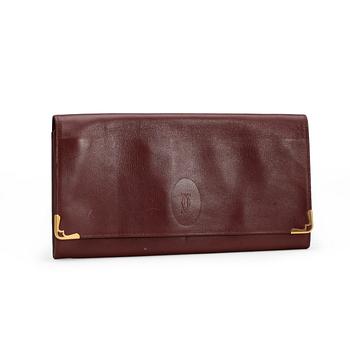 CARTIER, a red leather clutch or travel wallet.