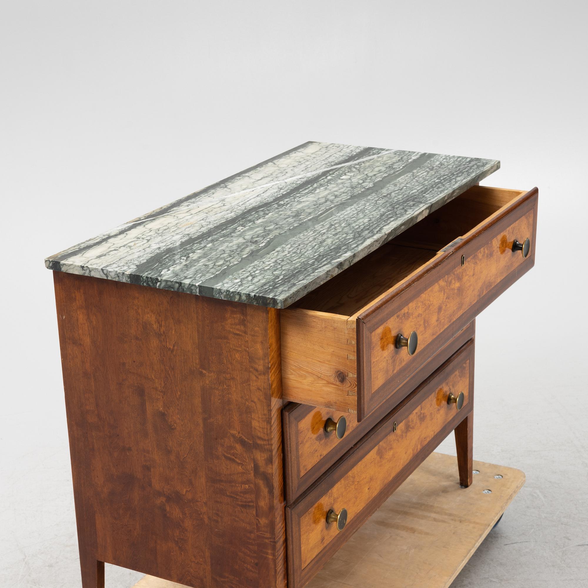 A mahogany and birch veneered dresser with a stone top.