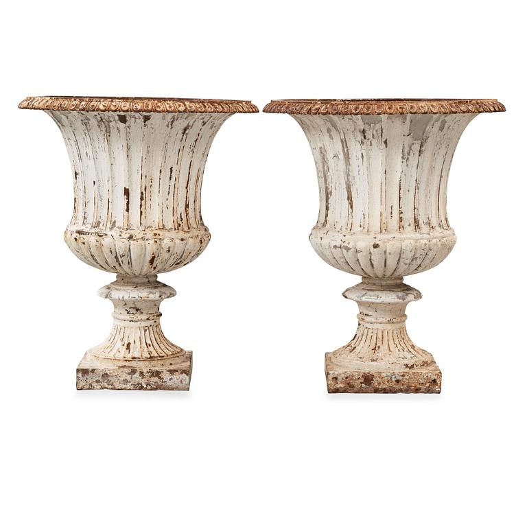 A pair of English 1860's iron garden urns.