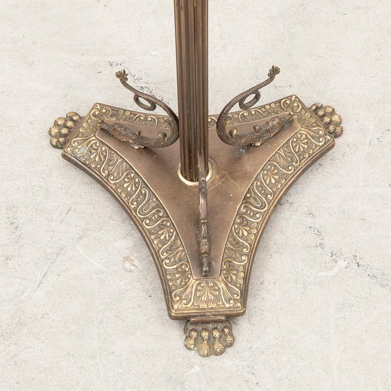 A brass coat hanger from the first half of the 20th century.