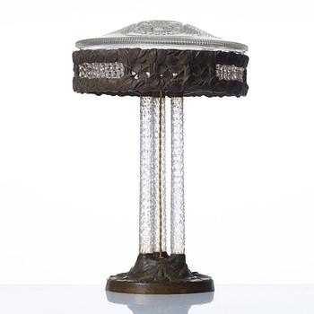 A Swedish Art Nouveau patinated brass and cut glass table lamp, Böhlmark's, Stockholm 1909-20.