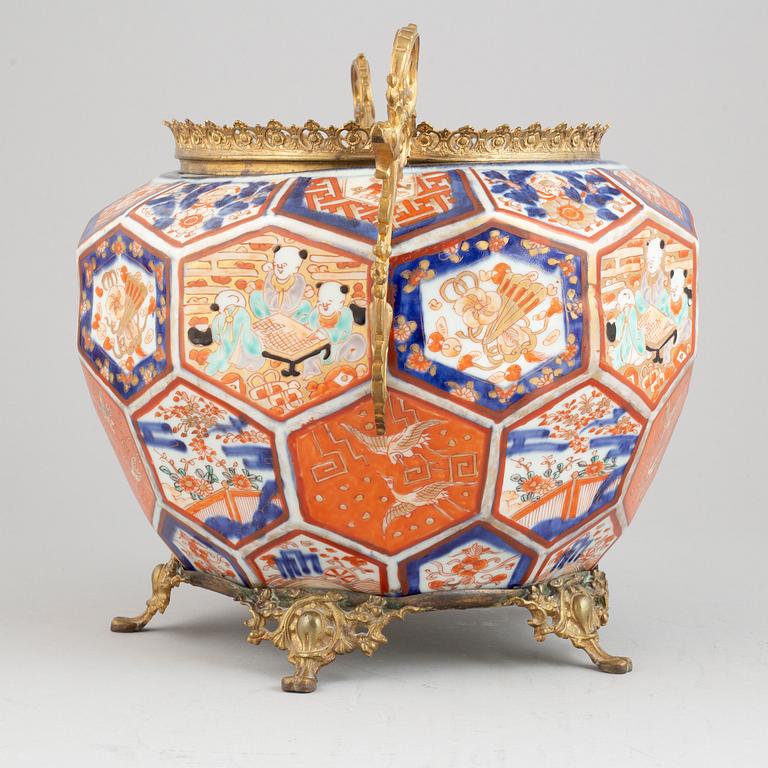 A Japanese plant pot with brass mounts, late 19th century.