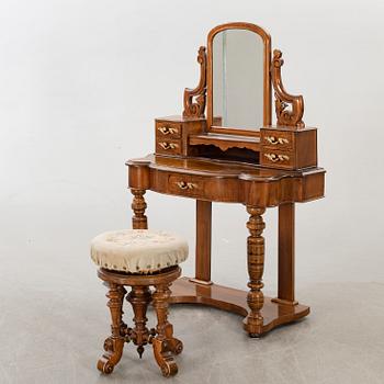 A second half of the 19th century table with mirror and a stool.