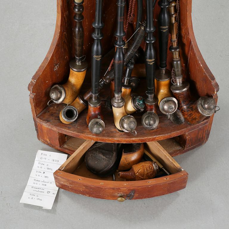 A 19th century pipe-rack with ten pipes and accessories.