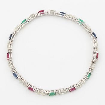Bracelet 18K white gold set with faceted rubies, emeralds, sapphires, and round brilliant-cut diamonds.