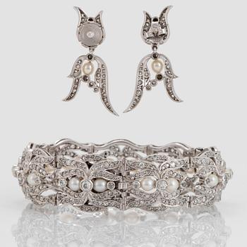 A platinum bracelet and a pair of earrings set with pearls and old-, eight- and rose-cut diamonds.