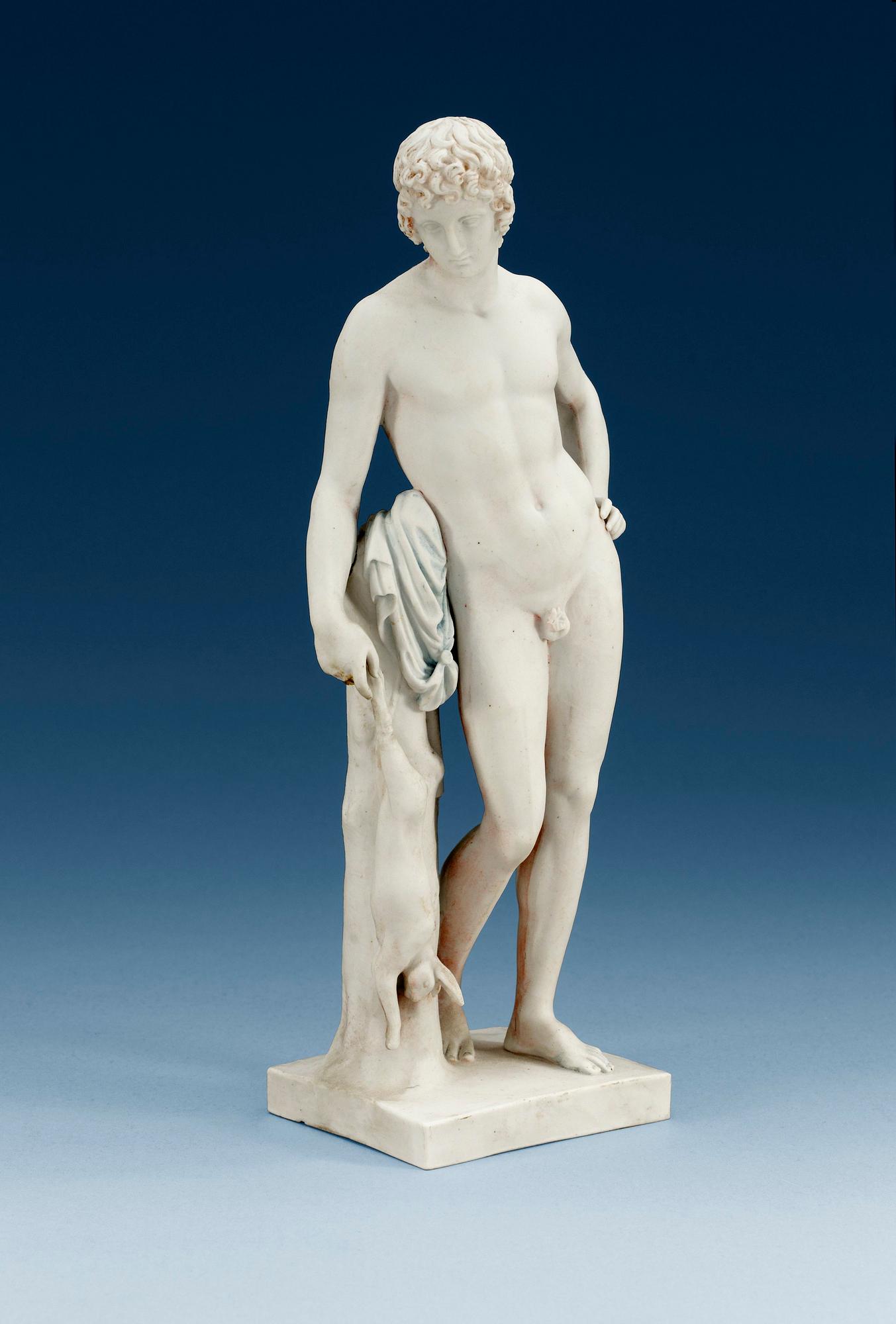 A Royal Copenhagen bisquit figure of a young man, 19th Century.