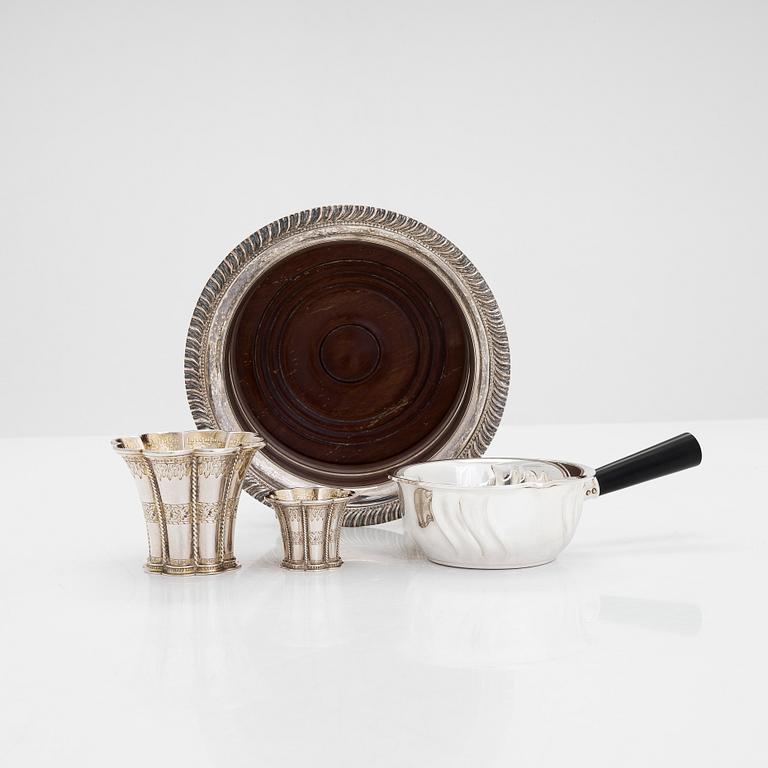 Two miniature beakers and a butter pan, Copenhagen, 1950s, and a silver-plated bottle coaster.