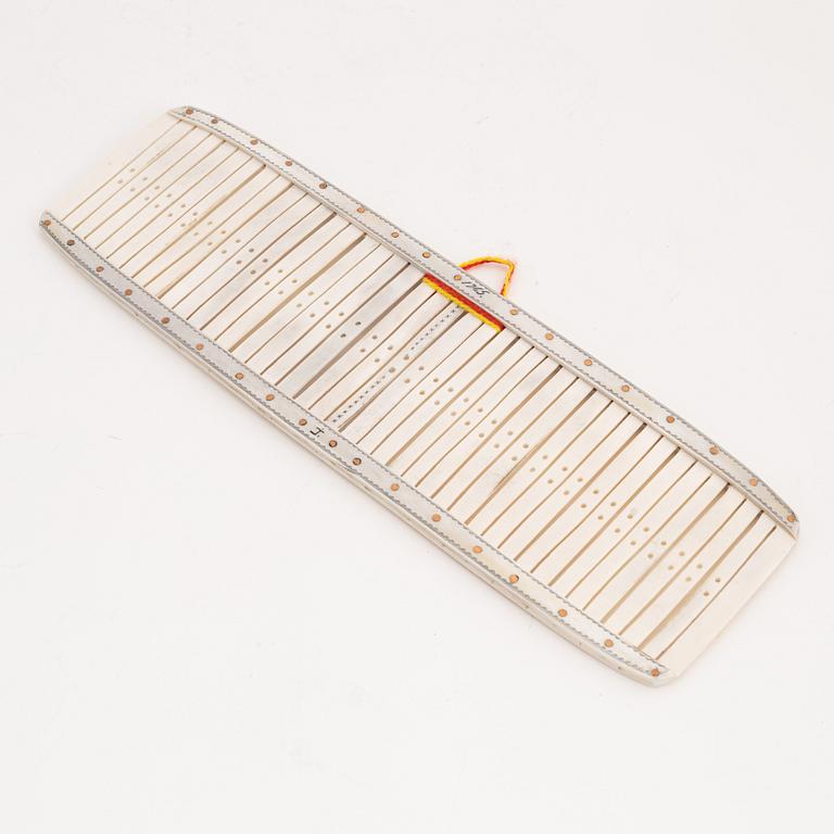 A reindeer weaving device by Johan Tuuri, signed and dated 1965.