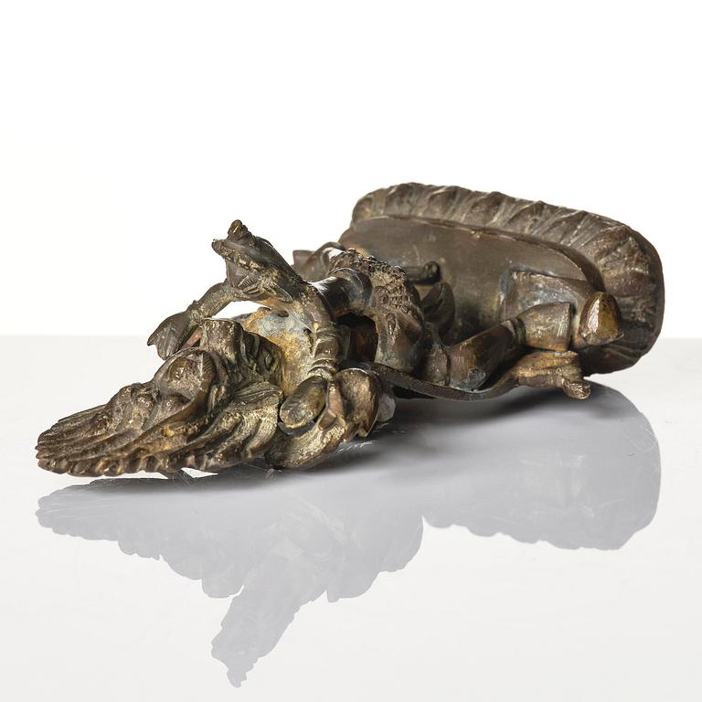 A bronze deity and a brass sacrificial bowl, Tibet, circa 1900.