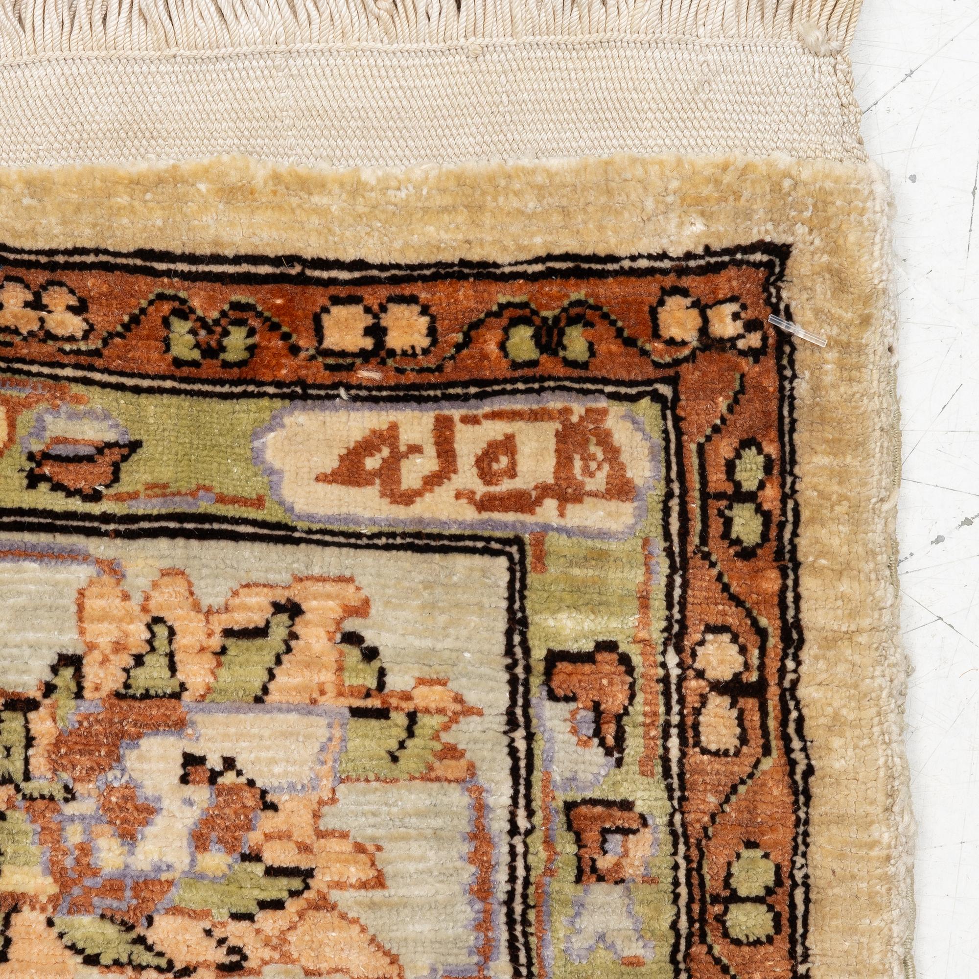 An oriental, silk rug, signed, c. 175 x 125 cm.