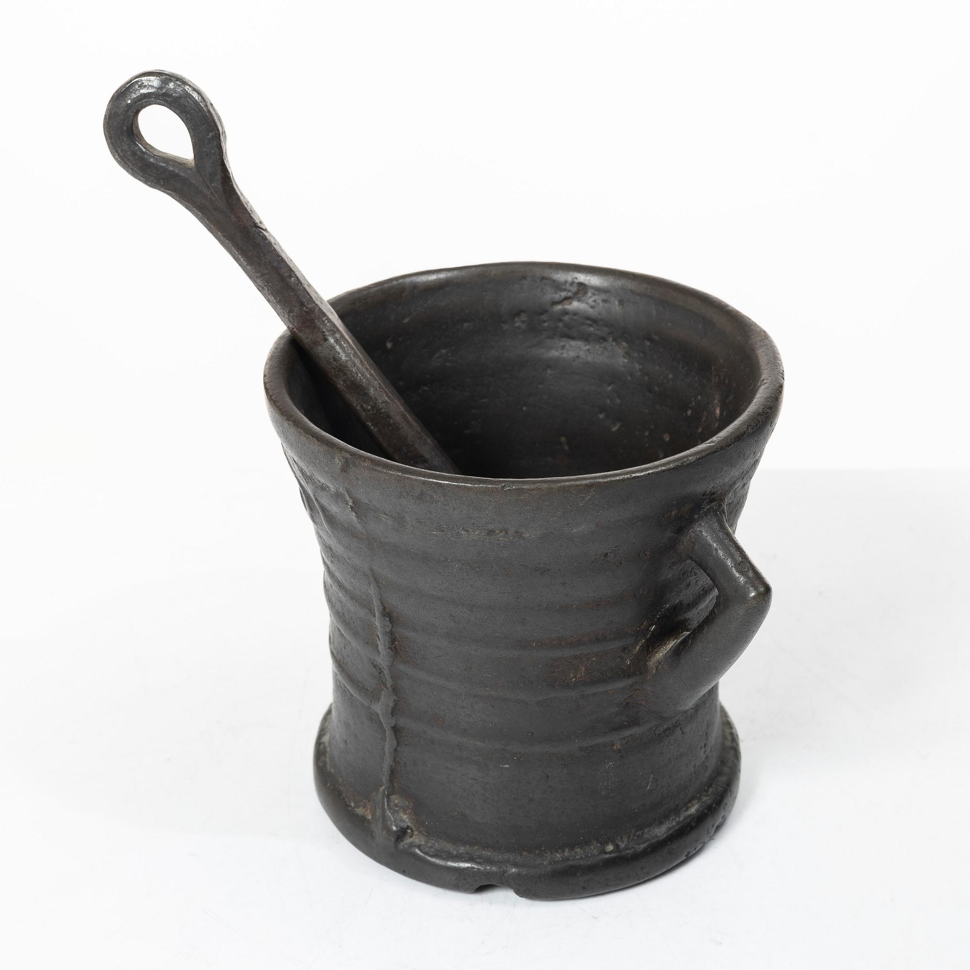 Mortar and pestle, dated 1673.