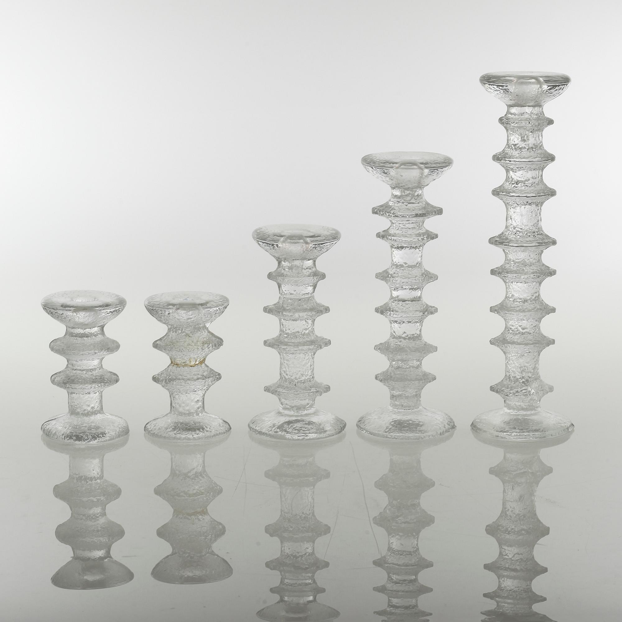 Five glass candlesticks by Timo Sarpaneva for Iittala, model "Festivo", second half of the 20th century.