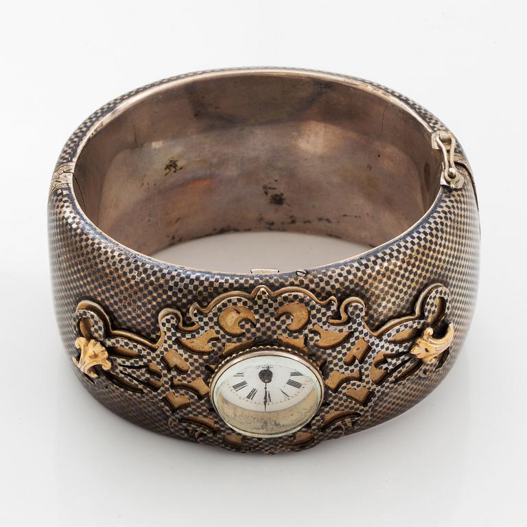 Silver bangle with watch.