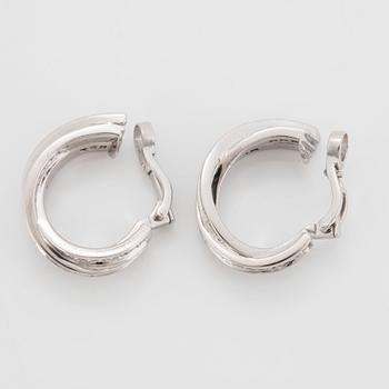 A pair of Cartier "Trinity" earrings in 18K white gold set with round brilliant-cut diamonds.