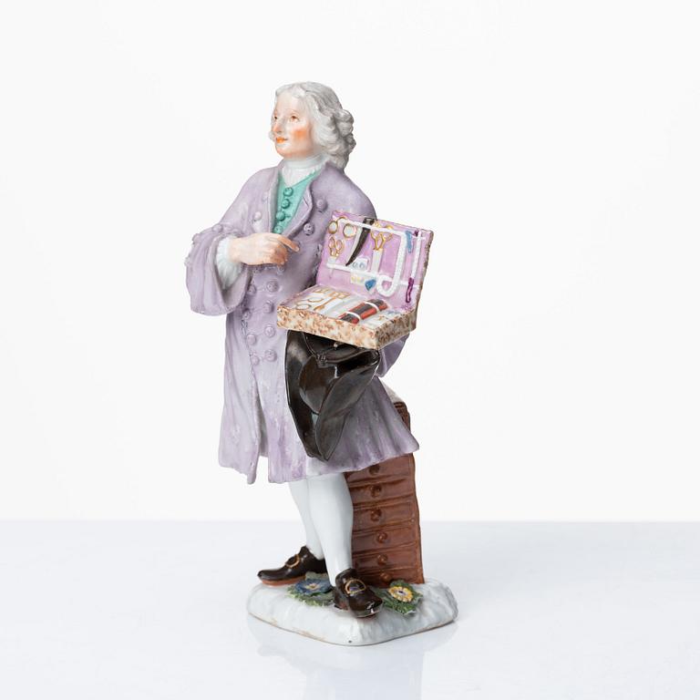 A Meissen porcelain figure of a trinket salesman from the series of Parisian street-traders, circa 1745.