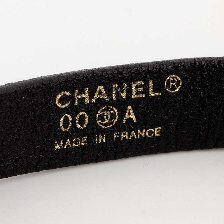 CHANEL, a leather bracelet.
