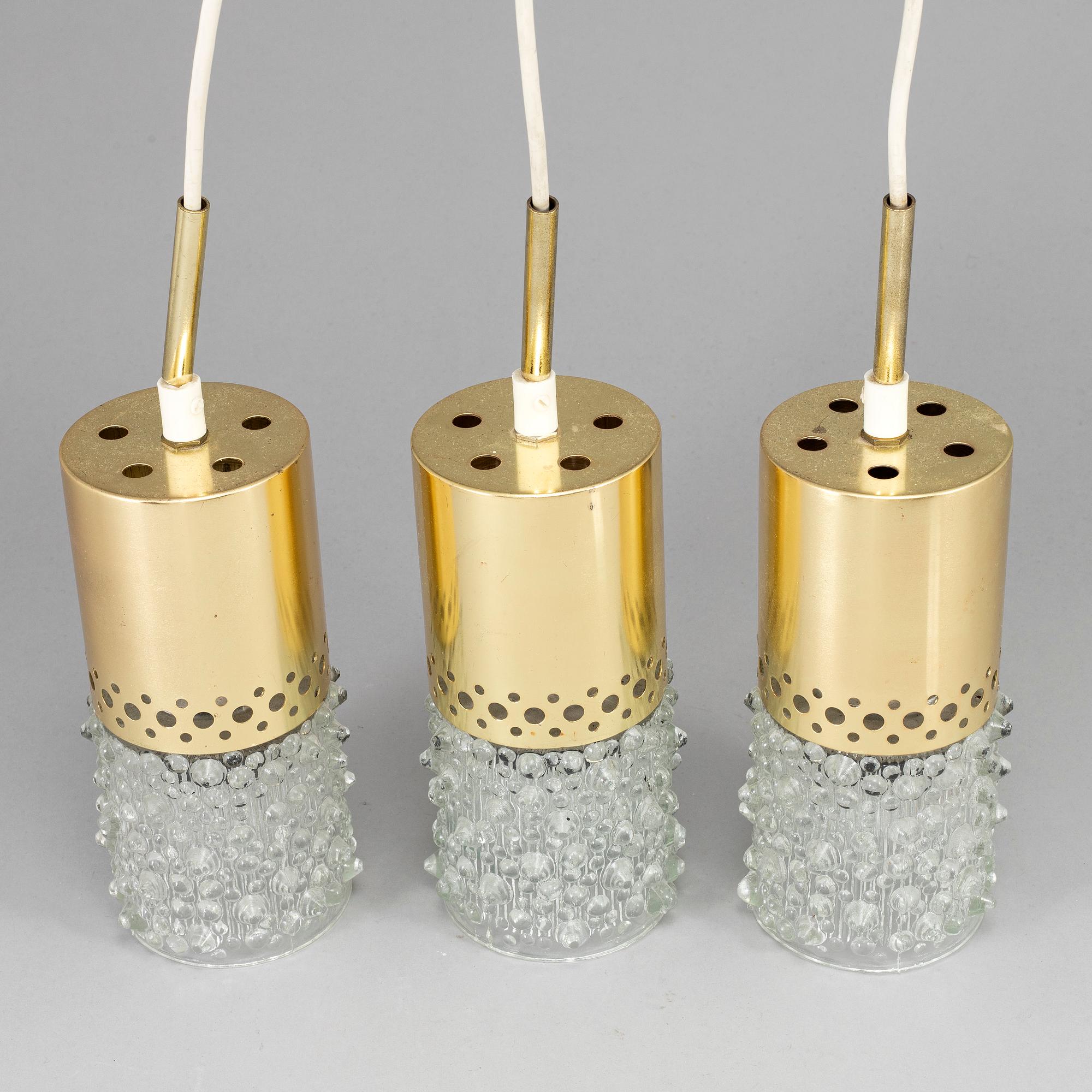 Three brass and glass pendant lights, 1960's.