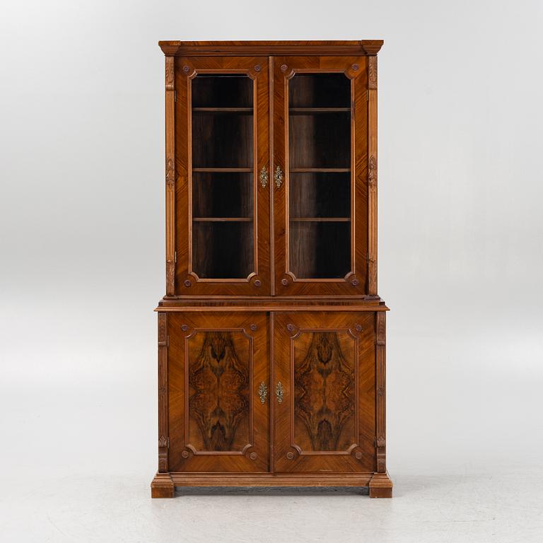 A walnut veneered book cabinet, second part of the 20th Century.