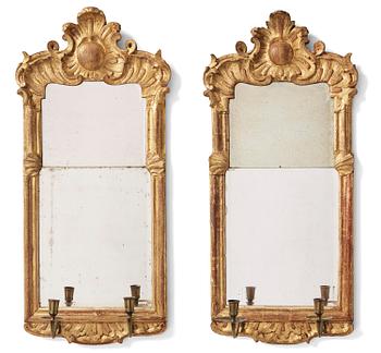 112. A pair of rococo giltwood two-branch girandoles, Stockholm, later part 18th century.