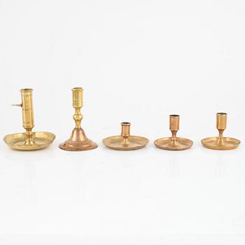 Five brass candlesticks, 18th century.