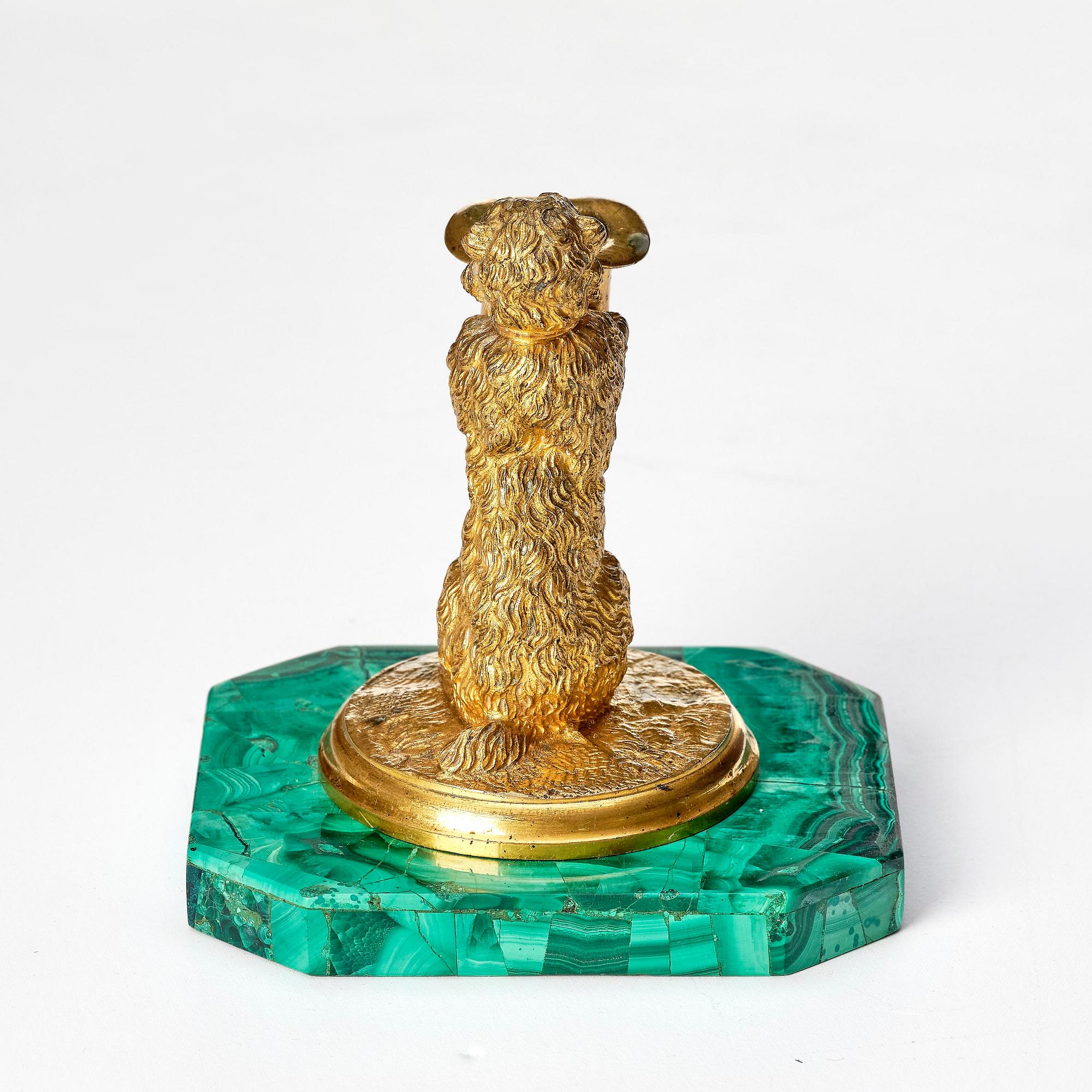 A Russian Nicholas II malachite-veneered and gilt-bronze candlestick, late 19th century.