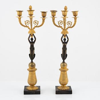 A pair of bronz empire style candelabras, 19th Century.