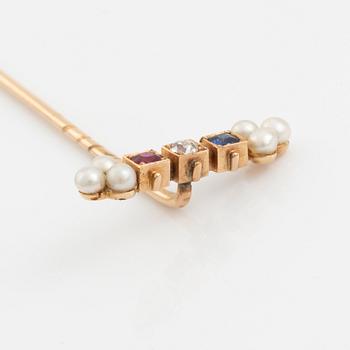 A 14K gold pin brooch with an old-cut diamond, pearls, and colored stones.