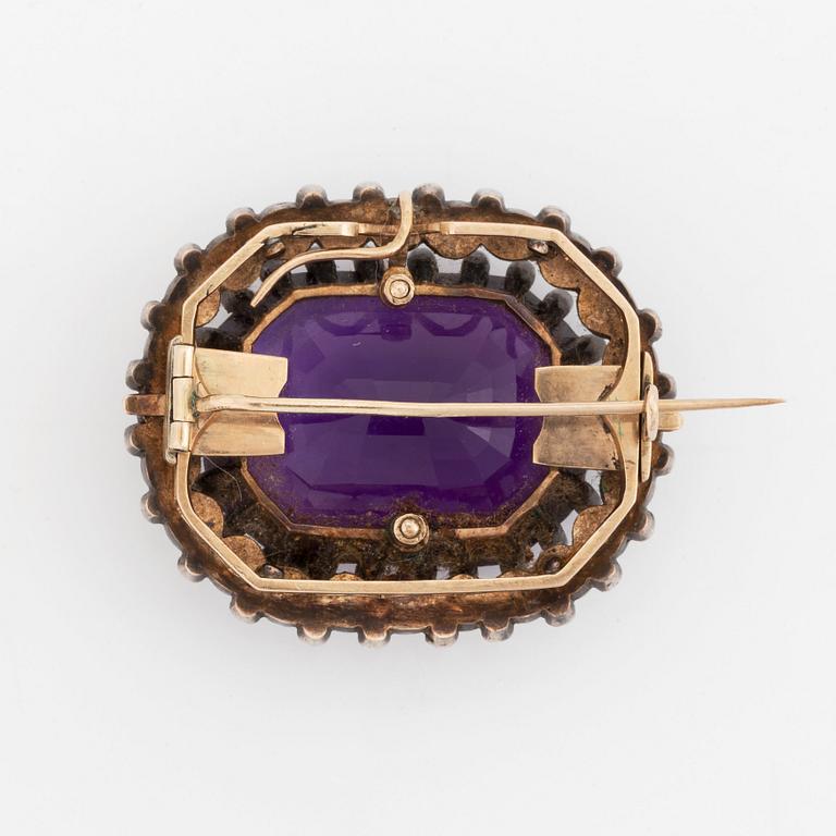 A silver and gold brooch/pendant set with an amethyst and pearls and rose-cut diamonds.