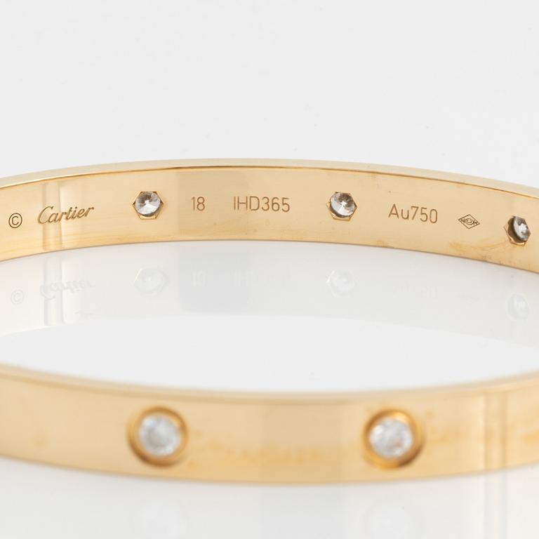 A Cartier "Love" bracelet in 18K gold set with ten round brilliant-cut diamonds.