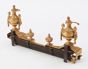 A pair of French Louis XVI-style 19th century gilt bronze fire dogs.