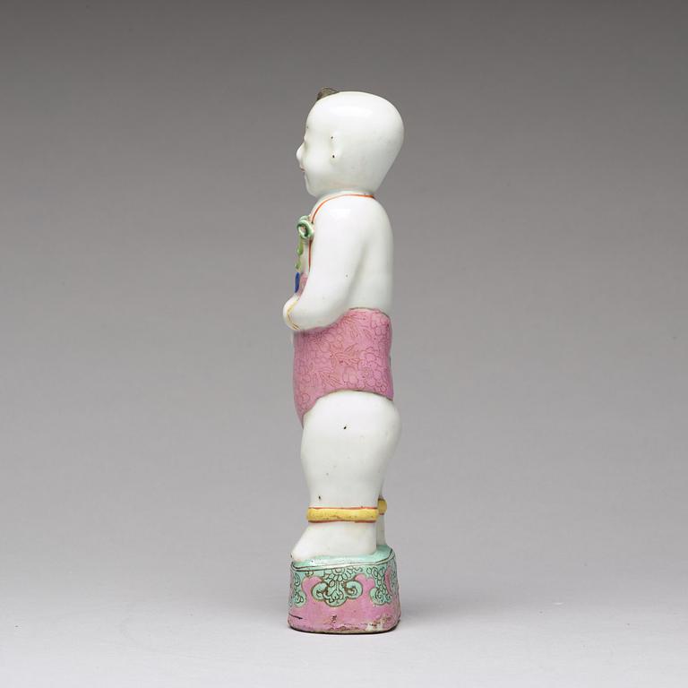 A famille rose porcelain figure of a laughing boy, Qing dynasty, 18th Century.