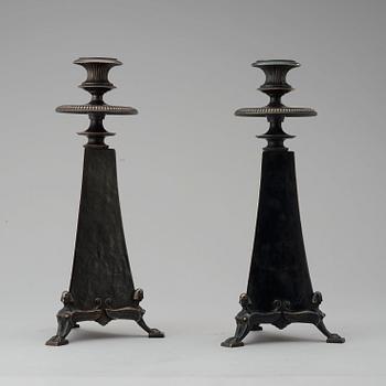 A pair of Melchior Wernstedt patinated bronze candlesticks, by Herman Bergman, Stockholm 1925.