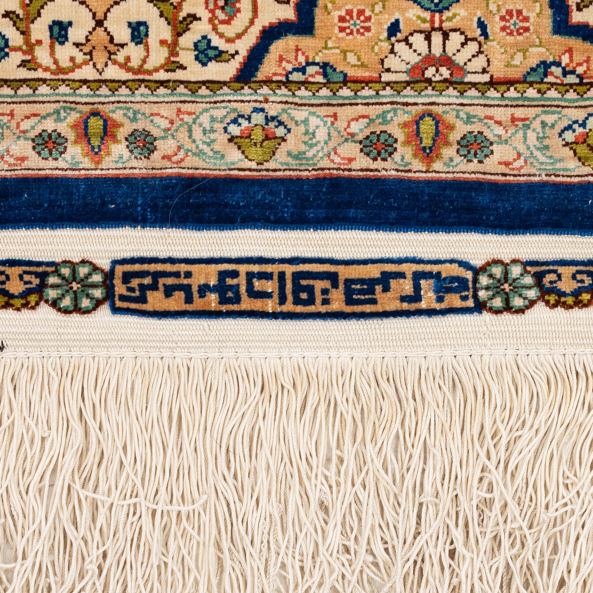 A semi-antique silk Hereke rug, West Anatolia, signed c. 107 x 72 cm.