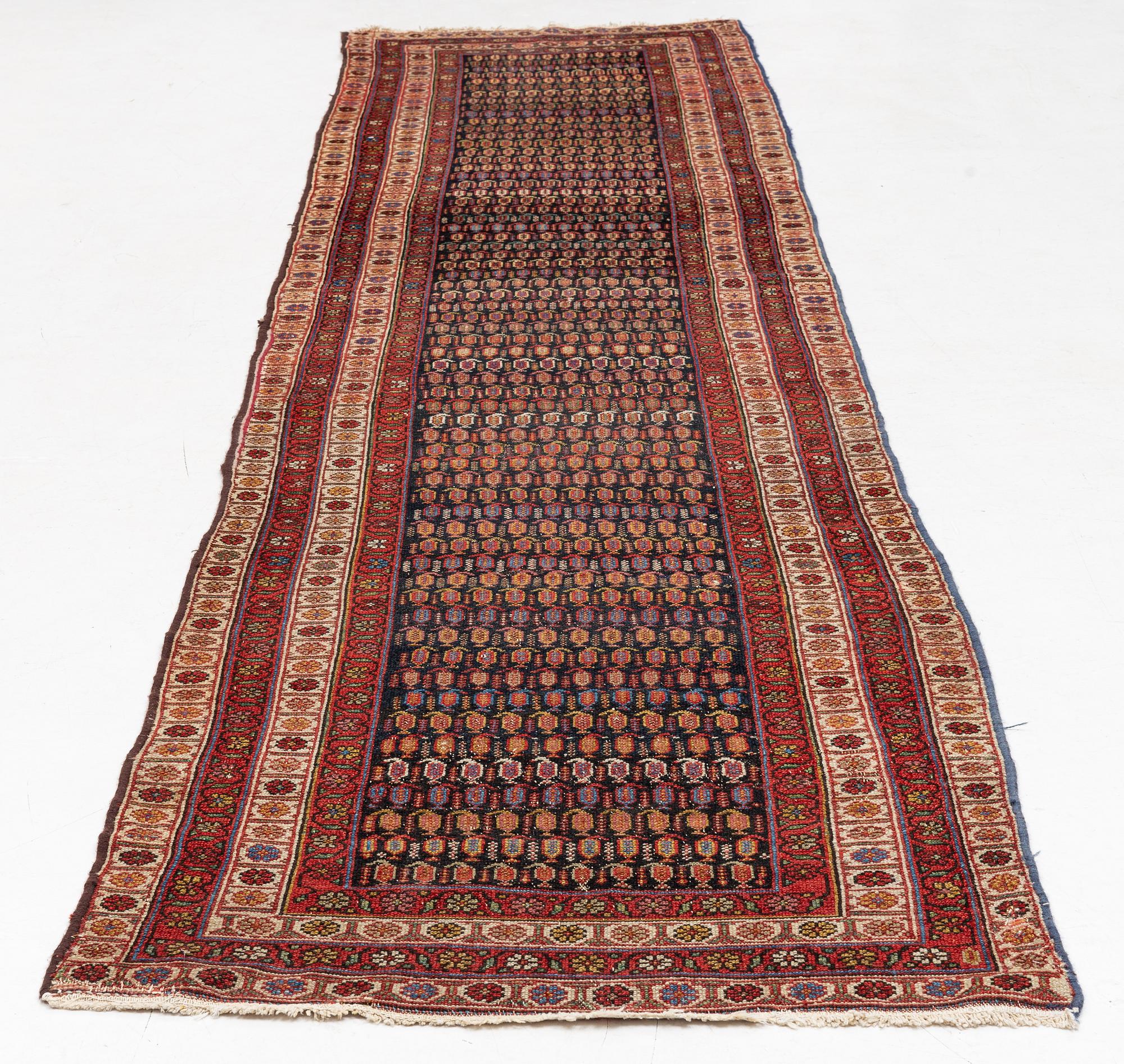 An antique runner carpet, approx. 400 x 93 cm.