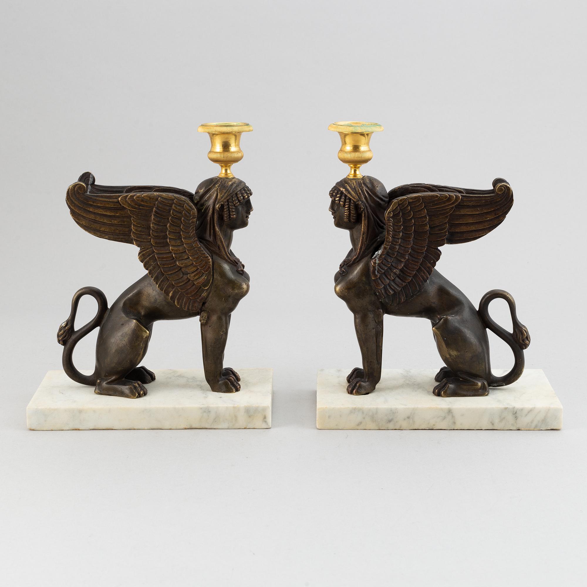 A pair of bronze and marble Empire style candlesticks, first part of the 20th Century.