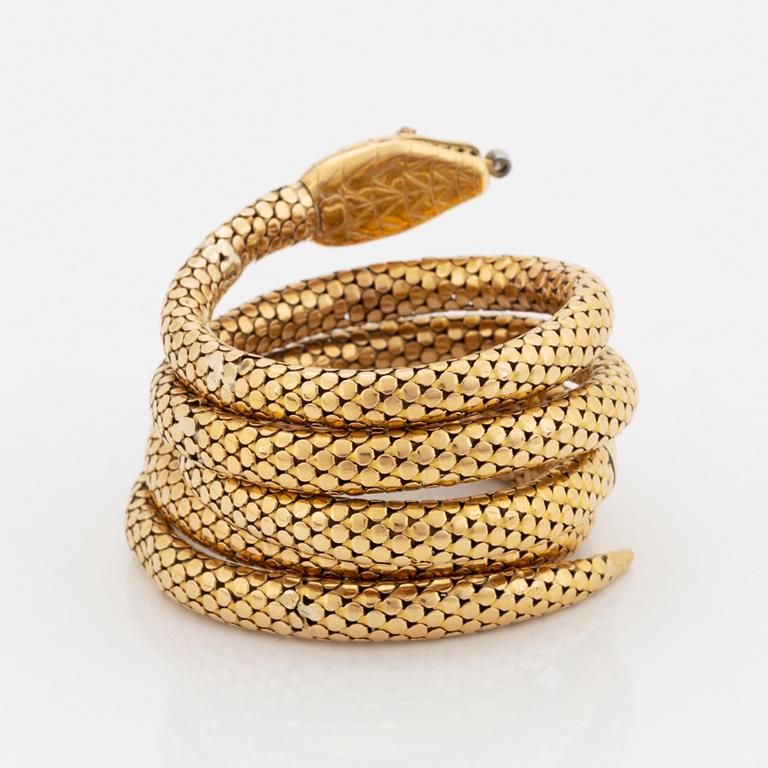 An 18K gold snake bracelet.