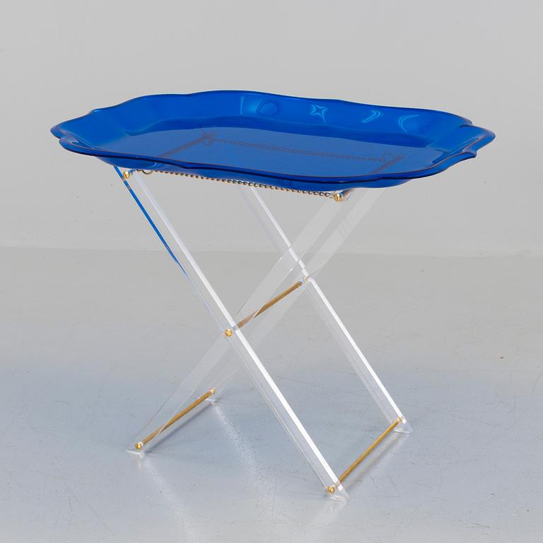 A plastic tray table, probably from Spisani, Italy.