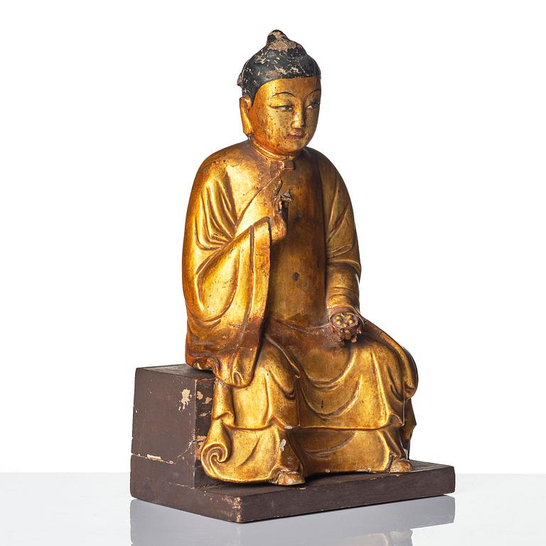 A gilt and polychrome lacquer figure of a divinity, 16th/17th century.