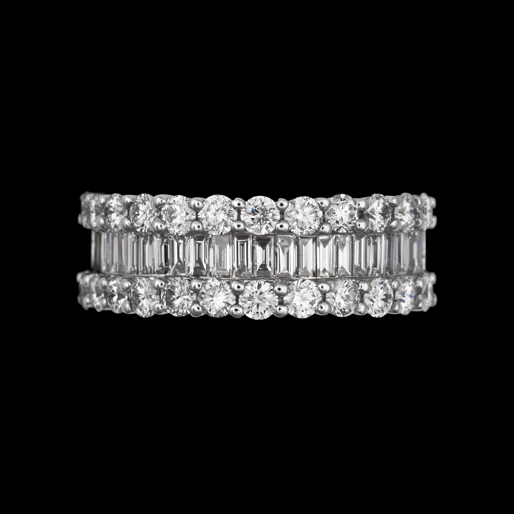 A brilliant- and emerald cut diamond ring.